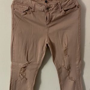 Blush colored ripped skinny jeans